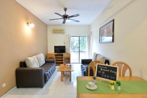 a living room with a couch and a table at Kijal Family Apartment in Kijal