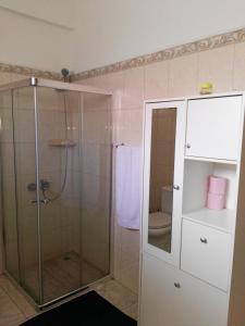 a bathroom with a shower and a toilet at Casa da Luz - Appartement in Mindelo