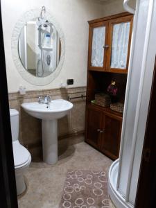 a bathroom with a sink and a toilet and a mirror at Casa Julia De Lozano in Rinlo +40 photos