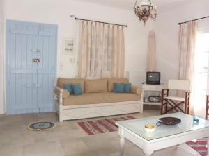 a living room with a couch and a table at Karades Houses Medusa in Plaka +20 photos