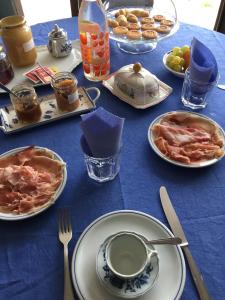 a blue table with plates of food on it at Orto dei Semplici in Farini dʼOlmo