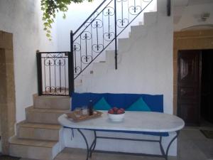 a table with a bowl of fruit on it next to a staircase at Patriko Country House in Vóroi