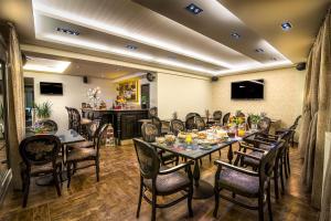 a dining room with a long table and chairs at Pansion Zafeiriou in Kastoria