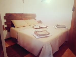 a bedroom with a bed with towels on it at La Dolce Vita Country House with pool - Solicchiata in Castiglione di Sicilia +19 photos