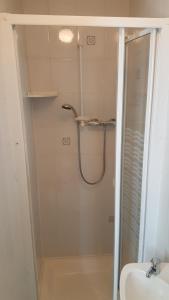 a bathroom with a shower and a sink at The Ratcliffe Guest House in Paignton