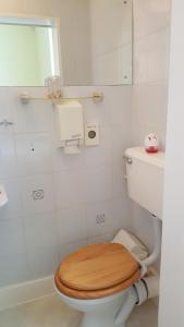 a bathroom with a toilet with a wooden toilet seat at The Ratcliffe Guest House in Paignton
