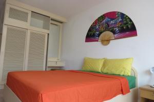 a bedroom with a bed with an orange blanket at View Talay 1B Residence in Pattaya South +85 photos
