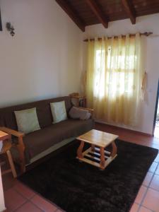 a living room with a couch and a coffee table at Quinta da quebrada in Santana