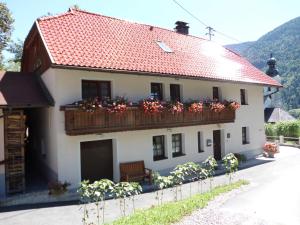 ein Haus mit einem Balkon mit Blumen darauf in der Unterkunft Fewo-Lenz in Hermagor