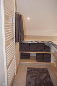 a walk in closet with wooden shelves and towels at Chalet an der Traun in Ebensee