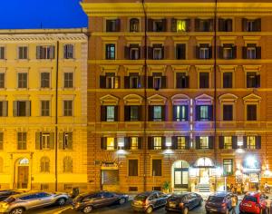 a large building with cars parked in front of it at La Casa di Nonna Rosa in Rome