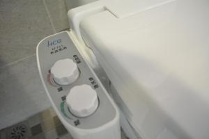 a close up of a white object in a bathroom at de rěve Express Hotel in Chiayi City