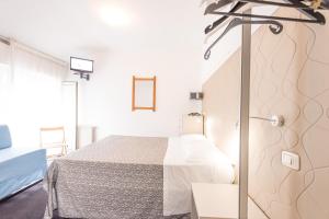 Rúm í herbergi á Hotel Rubino