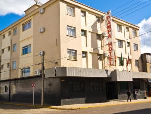a building on the corner of a street at Pampa Hotel in Vacaria