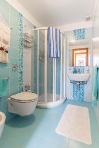 a bathroom with a shower and a toilet and a sink at La Casa di Romi in Marina di Ragusa +31 photos