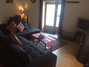 a living room with a couch and a coffee table at Ferme Dowena in Morillon