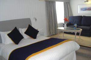 a hotel room with a bed and a couch at Trearddur Bay Hotel in Trearddur
