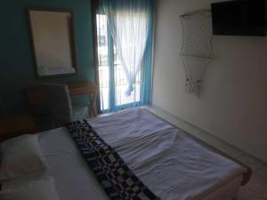 A bed or beds in a room at Villa Maria Apartments