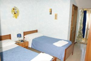 A bed or beds in a room at La Conca D'oro