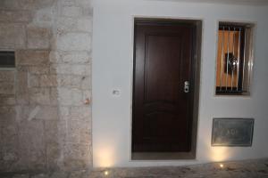 a wooden door in a room with a stone wall at Liberty Bell in Ostuni