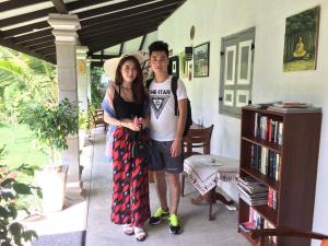 a man and a woman standing in front of a house at Green Wood Villa Negombo in Negombo