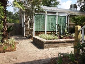 a house with a fence and a brick patio at Jingle Bells Square Cottage-Historic District-Bright- Fireplace in Savannah