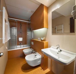 a bathroom with a sink and a toilet at Hotel Yoldi in Pamplona