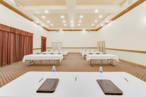 a room with white tables and chairs in it at Lone Star Inn - San Benito Harlingen in San Benito +7 photos