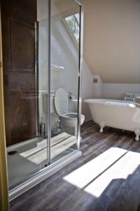 a bathroom with a tub and a toilet and a sink at The Charlton Arms in Ludlow