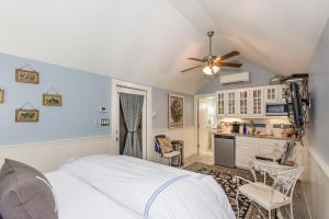 a bedroom with a bed and a kitchen at Agape Cottage in Fredericksburg