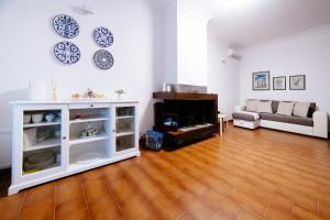 a living room with a couch and a fireplace at Sea View Villa in Ravello with lemon pergola, gardens and jacuzzi - Ideal for elopements in Ravello