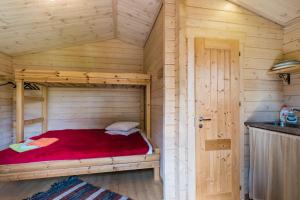 a bedroom with a bed in a wooden cabin at Reta Puhkemajad in Haapsalu