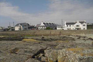 a group of houses in a town with rocks at Trearddur Bay Hotel in Trearddur