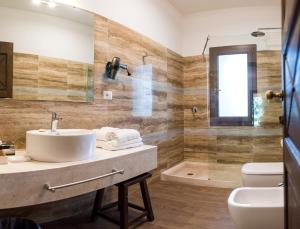 a bathroom with a sink and a shower at Hotel Costa dei Fiori in Santa Margherita di Pula