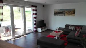 a living room with a couch and a table at Appartement Grießenkareck in Flachau