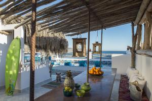 a room with a table with fruit and a view of the ocean at Munga Guesthouse in Taghazout