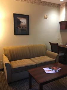 a living room with a couch and a table at Hawthorn Suites by Wyndham Rancho Cordova/Folsom in Rancho Cordova
