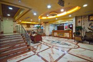 a lobby with a staircase and a lobby at Diyar Taiba Hotel in Medina