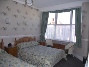 A bed or beds in a room at Ginnie's Guesthouse 