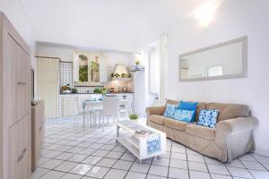 a living room with a couch and a table at Cartiera Apartment with Pool by AMALFIVACATION in Amalfi