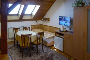 a kitchen with a table and chairs in a room at Penzion Kapitan in Jindřichŭv Hradec