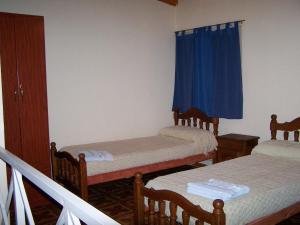 Postel nebo postele na pokoji v ubytování Cabañas y Hotel Ebemys