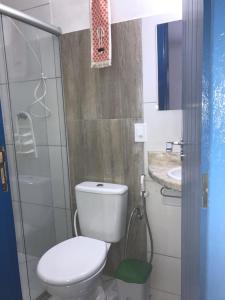 a small bathroom with a toilet and a sink at Recanto das Geraes in Arraial d'Ajuda