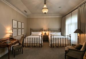 a bedroom with two beds and a table and a couch at The Genevieve in Santa Ynez