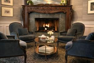 a waiting room with chairs and a fireplace at The Genevieve in Santa Ynez