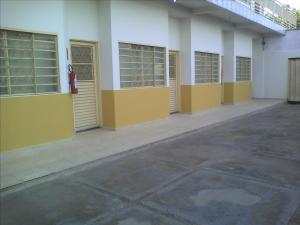 a row of yellow doors on a building at Hotel Capim Dourado in Palmas