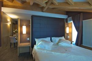 Postel nebo postele na pokoji v ubytování Hotel Garni Vittoria