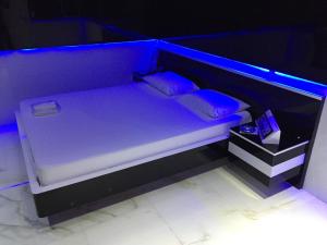 Postel nebo postele na pokoji v ubytování MOTEL LIBIDUS - Foz do Iguaçu
