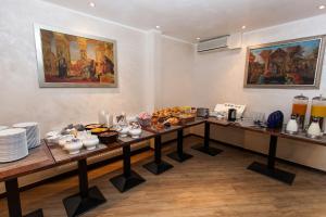 a buffet line with a lot of food on it at Central Hotel am Dom - Köln City in Cologne