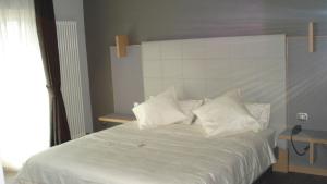 Postel nebo postele na pokoji v ubytování Hotel Garni Vittoria
